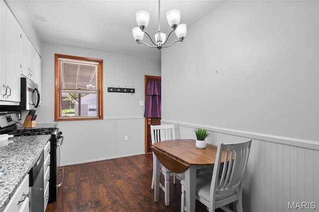 512 N Hills Dr, Saint Louis, MO 63121 - dining room with wainscoting, dark wood finished floors, and a chandelier