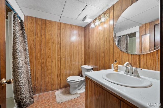 512 N Hills Dr, Saint Louis, MO 63121 - bathroom featuring a paneled ceiling, wooden walls, vanity, and tile patterned flooring