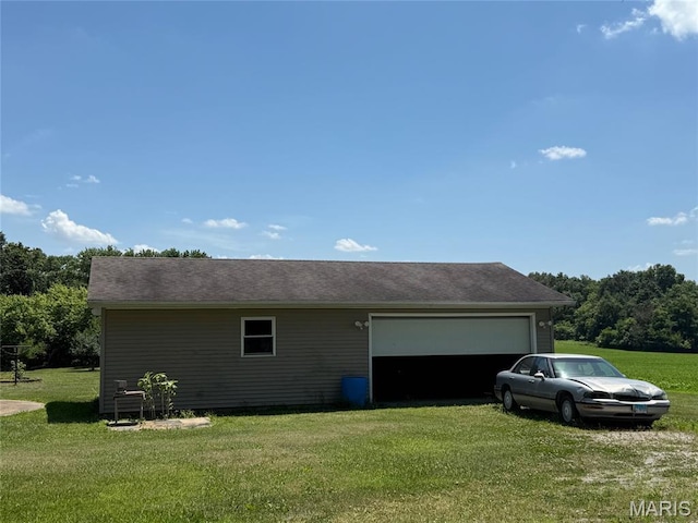 299 E 3050th Ave, Ramsey, IL 62080 - view of home's exterior with a garage, a lawn, an outdoor structure, and driveway