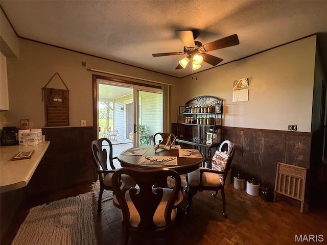 299 E 3050th Ave, Ramsey, IL 62080 - dining room featuring a wainscoted wall, a ceiling fan, a textured ceiling, and wood walls