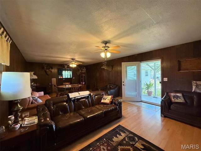 299 E 3050th Ave, Ramsey, IL 62080 - living area featuring wooden walls, wood finished floors, a ceiling fan, and a textured ceiling