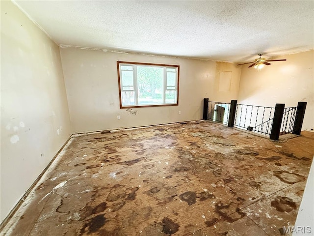 335 Sumac St, Payson, IL 62360 - empty room featuring a textured ceiling and a ceiling fan
