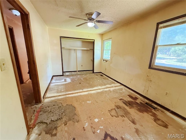 335 Sumac St, Payson, IL 62360 - unfurnished bedroom featuring a textured ceiling, a closet, and ceiling fan