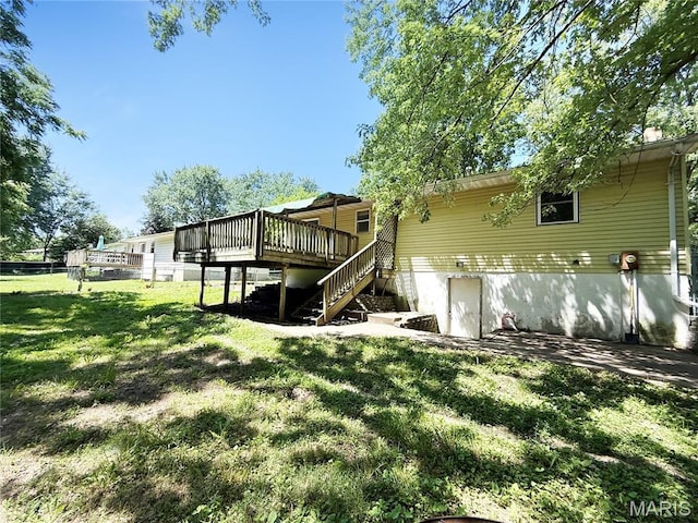 335 Sumac St, Payson, IL 62360 - back of property with stairs, a wooden deck, and a yard