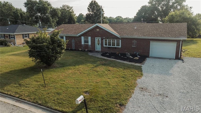 119 Freedom Dr, Belleville, IL 62226 - ranch-style home featuring an attached garage, gravel driveway, brick siding, and a front yard