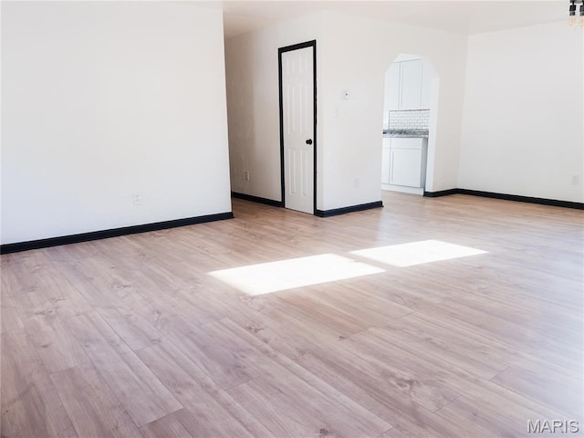 119 Freedom Dr, Belleville, IL 62226 - spare room with light wood-style flooring and arched walkways