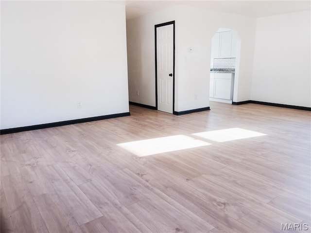 119 Freedom Dr, Belleville, IL 62226 - unfurnished room featuring light wood finished floors and arched walkways