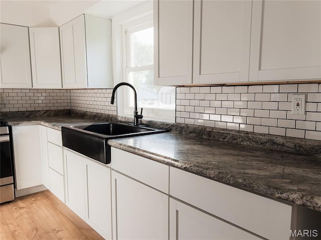119 Freedom Dr, Belleville, IL 62226 - kitchen featuring white cabinets, dark countertops, and tasteful backsplash