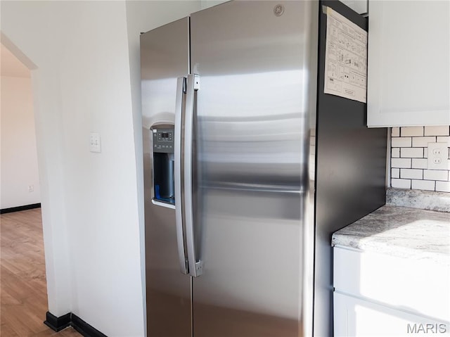 119 Freedom Dr, Belleville, IL 62226 - kitchen with stainless steel fridge with ice dispenser, wood finished floors, arched walkways, white cabinets, and backsplash