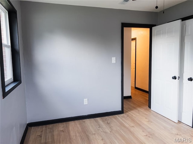119 Freedom Dr, Belleville, IL 62226 - unfurnished bedroom featuring light wood-style floors and baseboards