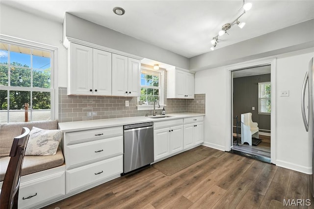 7616 Suffolk Ave, Saint Louis, MO 63119 - kitchen featuring stainless steel dishwasher, light countertops, dark wood-style flooring, and white cabinetry