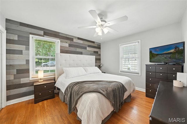 7616 Suffolk Ave, Saint Louis, MO 63119 - bedroom with wood finished floors, wood walls, and ceiling fan