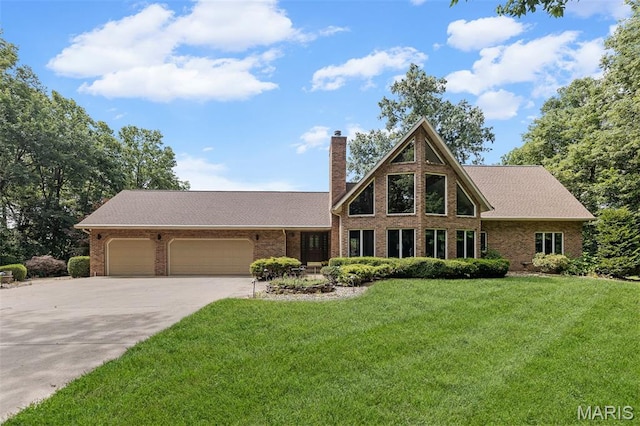4775 S Hazel Rd, Edwardsville, IL 62025 - view of front of house with a garage, concrete driveway, a chimney, brick siding, and a front yard
