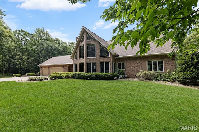 4775 S Hazel Rd, Edwardsville, IL 62025 - view of front of house with brick siding, a front yard, an attached garage, driveway, and roof with shingles