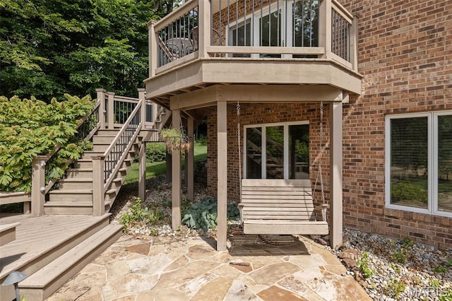 4775 S Hazel Rd, Edwardsville, IL 62025 - property entrance with brick siding, a patio, and a deck