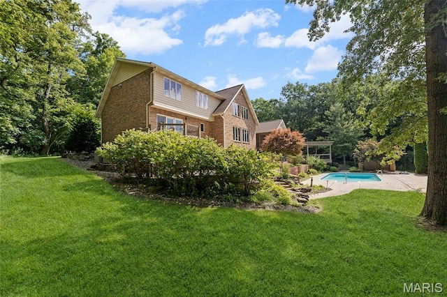 4775 S Hazel Rd, Edwardsville, IL 62025 - back of property featuring brick siding, a lawn, and an outdoor pool