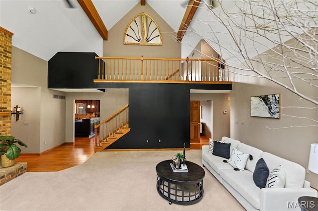 4775 S Hazel Rd, Edwardsville, IL 62025 - carpeted living room with stairway, high vaulted ceiling, and wood finished floors