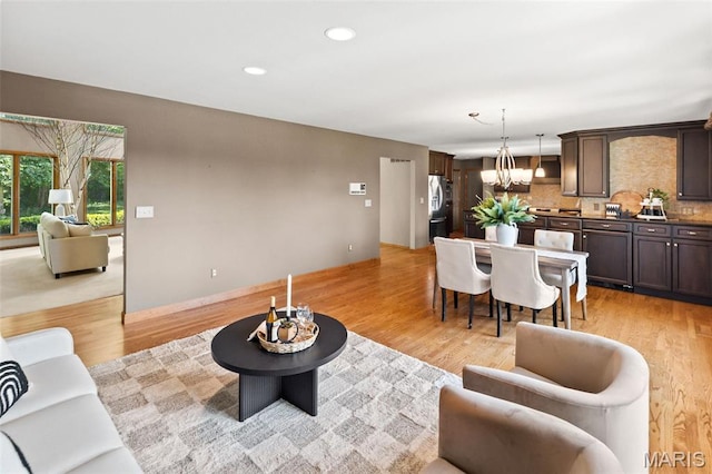 4775 S Hazel Rd, Edwardsville, IL 62025 - living room featuring a chandelier, light wood-type flooring, and recessed lighting