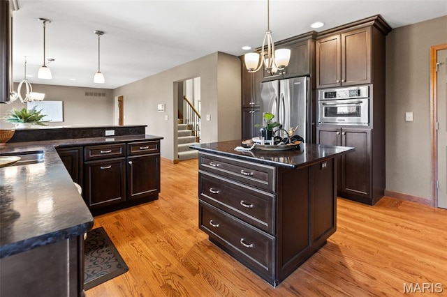 4775 S Hazel Rd, Edwardsville, IL 62025 - kitchen with stainless steel appliances, a chandelier, dark countertops, dark brown cabinetry, and recessed lighting