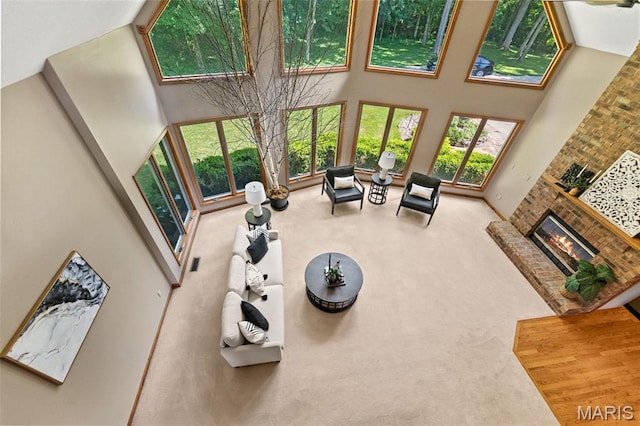 4775 S Hazel Rd, Edwardsville, IL 62025 - carpeted living room with a high ceiling and a brick fireplace