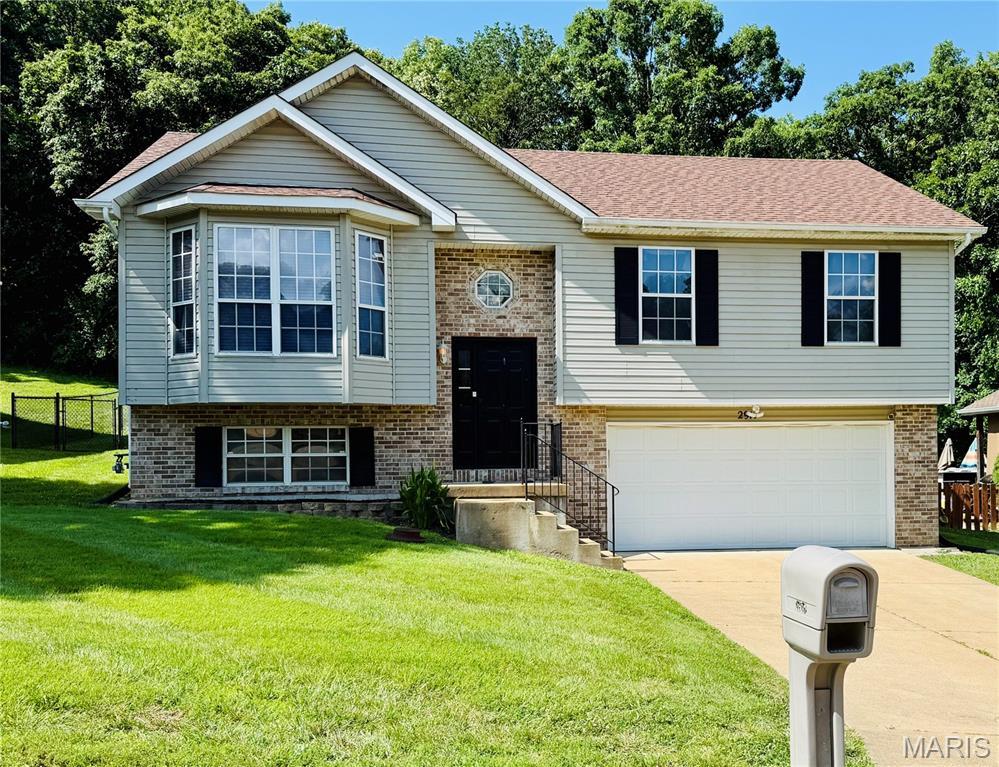 2917 Sand Sculpture Ct, Pevely, MO 63070 - bi-level home with driveway, brick siding, and an attached garage
