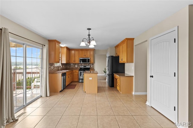 672 Berrywine Ln, Arnold, MO 63010 - kitchen with stainless steel appliances, decorative backsplash, a chandelier, light tile patterned floors, and a kitchen island