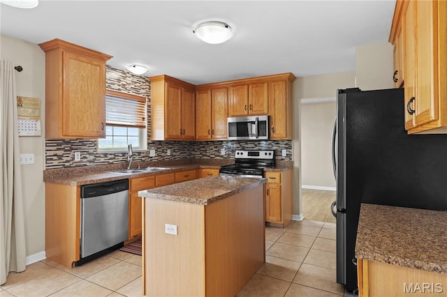 672 Berrywine Ln, Arnold, MO 63010 - kitchen featuring appliances with stainless steel finishes, backsplash, light tile patterned flooring, a center island, and dark countertops