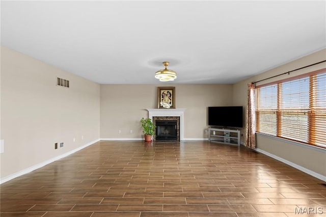 672 Berrywine Ln, Arnold, MO 63010 - unfurnished living room with a fireplace and dark wood-style floors