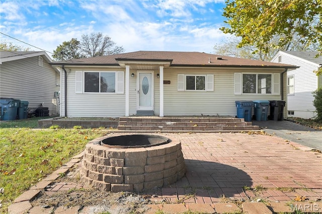 8219 Pear Ln, Saint Louis, MO 63123 - view of front facade with a fire pit and a patio