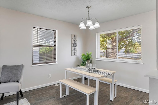 8219 Pear Ln, Saint Louis, MO 63123 - dining room featuring plenty of natural light, a chandelier, dark wood-style flooring, and a textured ceiling
