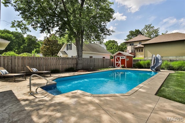 1029 Brownell Ave, Glendale, MO 63122 - view of swimming pool with a water slide, a patio area, a shed, and a fenced backyard