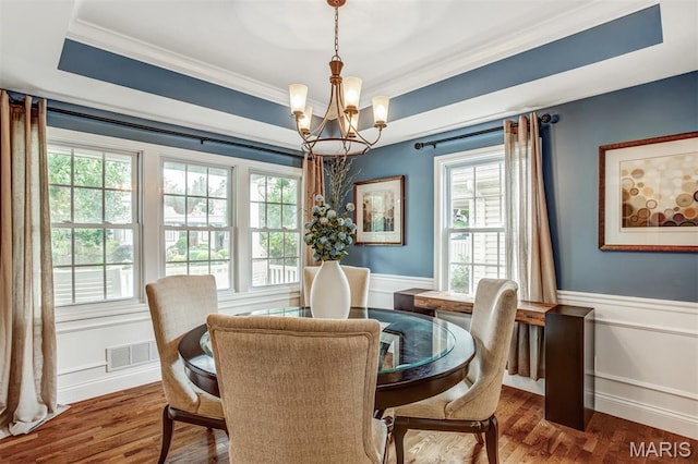 1029 Brownell Ave, Glendale, MO 63122 - dining area featuring a chandelier, ornamental molding, plenty of natural light, wainscoting, and wood finished floors
