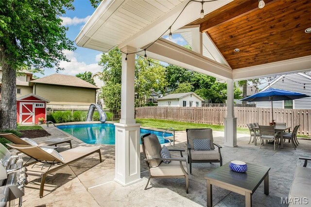 1029 Brownell Ave, Glendale, MO 63122 - view of pool featuring a water slide, a patio area, and a storage unit