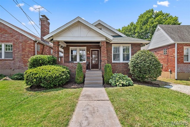 6016 Scanlan Ave, Saint Louis, MO 63139 - bungalow-style home with a front yard, brick siding, a chimney, and covered porch