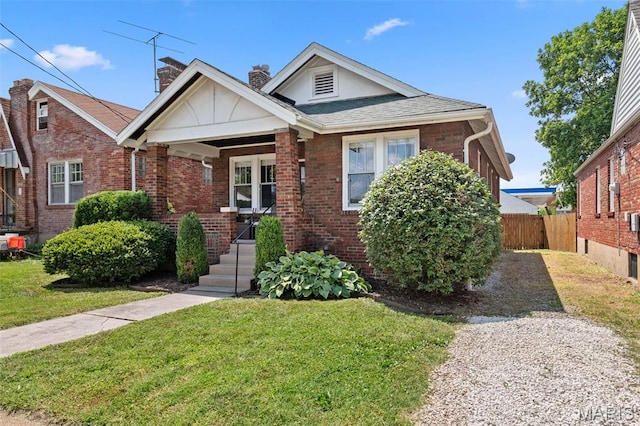 6016 Scanlan Ave, Saint Louis, MO 63139 - view of front of home featuring brick siding, a chimney, covered porch, and roof with shingles