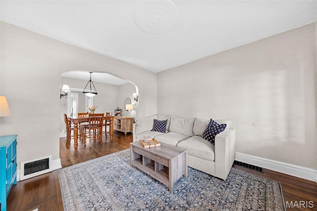 6016 Scanlan Ave, Saint Louis, MO 63139 - living area featuring arched walkways and wood finished floors