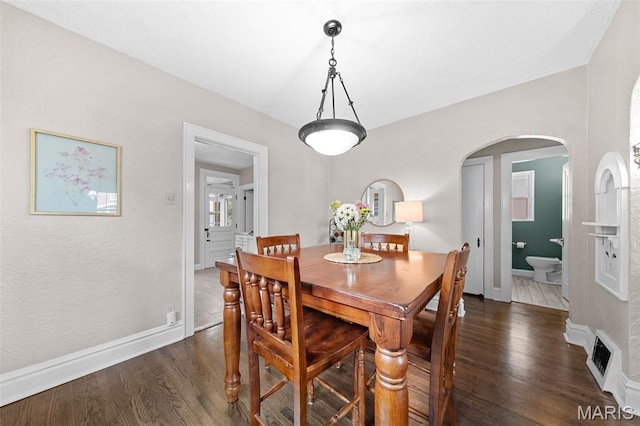 6016 Scanlan Ave, Saint Louis, MO 63139 - dining space featuring dark wood-type flooring and arched walkways