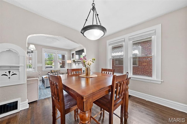 6016 Scanlan Ave, Saint Louis, MO 63139 - dining room featuring arched walkways and dark wood-style flooring