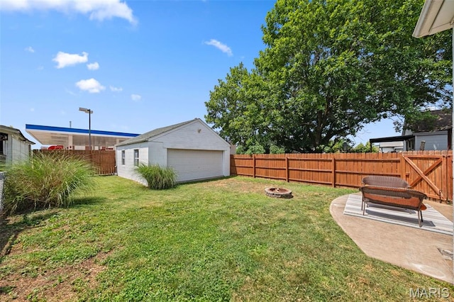 6016 Scanlan Ave, Saint Louis, MO 63139 - fenced backyard with a fire pit, an outbuilding, and a garage