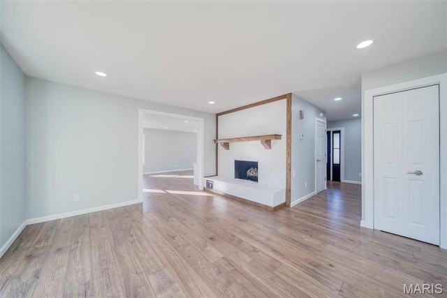 11880 County Road 3040, Rolla, MO 65401 - unfurnished living room with wood finished floors, a fireplace, and recessed lighting