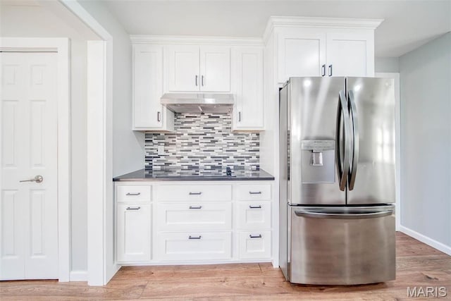 11880 County Road 3040, Rolla, MO 65401 - kitchen featuring stainless steel refrigerator with ice dispenser, under cabinet range hood, dark countertops, decorative backsplash, and white cabinets