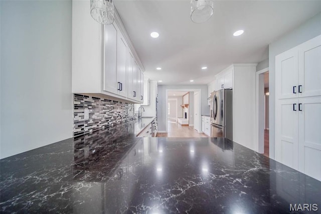 11880 County Road 3040, Rolla, MO 65401 - kitchen featuring freestanding refrigerator, tasteful backsplash, white cabinets, recessed lighting, and dark stone counters