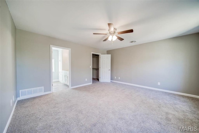 11880 County Road 3040, Rolla, MO 65401 - unfurnished bedroom with carpet, a walk in closet, connected bathroom, a ceiling fan, and a closet