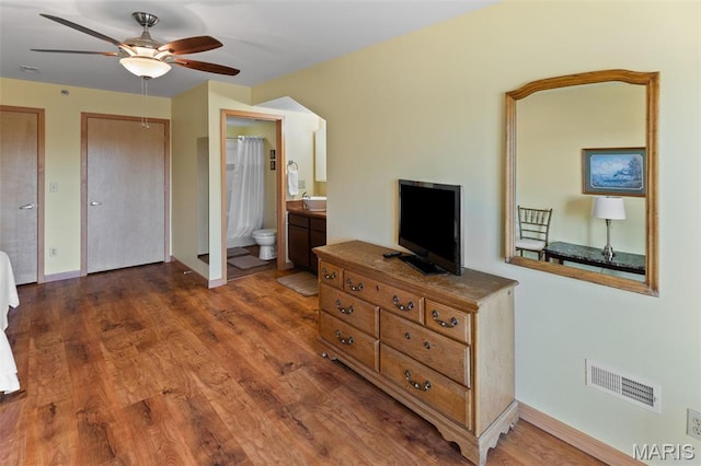 315 Timber Ridge Dr, Grafton, IL 62037 - bedroom with wood finished floors, connected bathroom, and ceiling fan