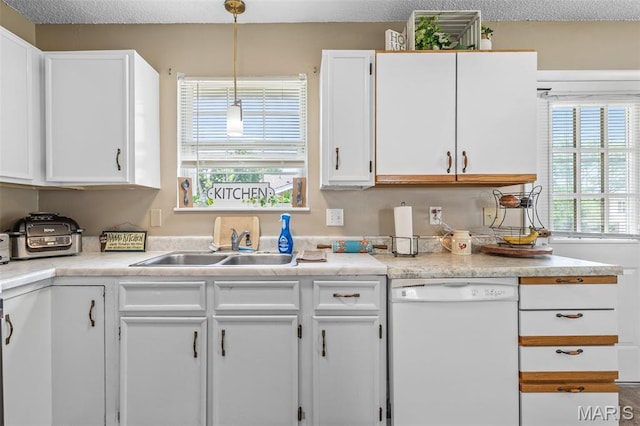 211 Congress St, Park Hills, MO 63601 - kitchen with dishwasher, white cabinets, light countertops, pendant lighting, and a textured ceiling