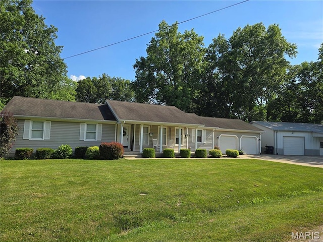 310 E 1st St, Ramsey, IL 62080 - single story home with covered porch, a garage, concrete driveway, and a front lawn