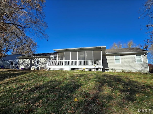 310 E 1st St, Ramsey, IL 62080 - rear view of house with a sunroom and a yard
