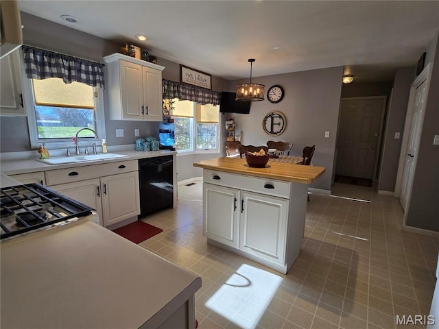310 E 1st St, Ramsey, IL 62080 - kitchen with dishwasher, a chandelier, light countertops, a kitchen island, and white cabinets