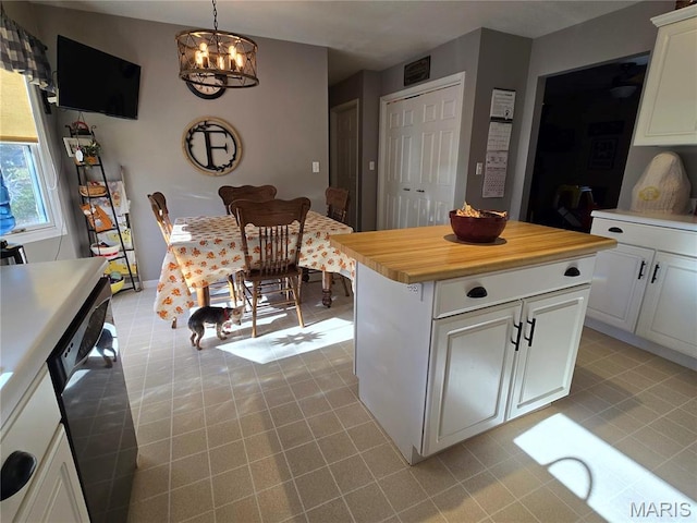 310 E 1st St, Ramsey, IL 62080 - kitchen featuring a chandelier, dishwashing machine, white cabinetry, wooden counters, and light tile patterned floors