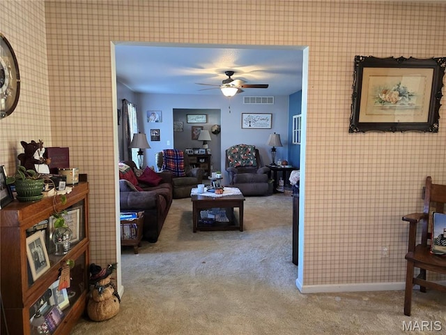 310 E 1st St, Ramsey, IL 62080 - living area with carpet, wallpapered walls, and a ceiling fan